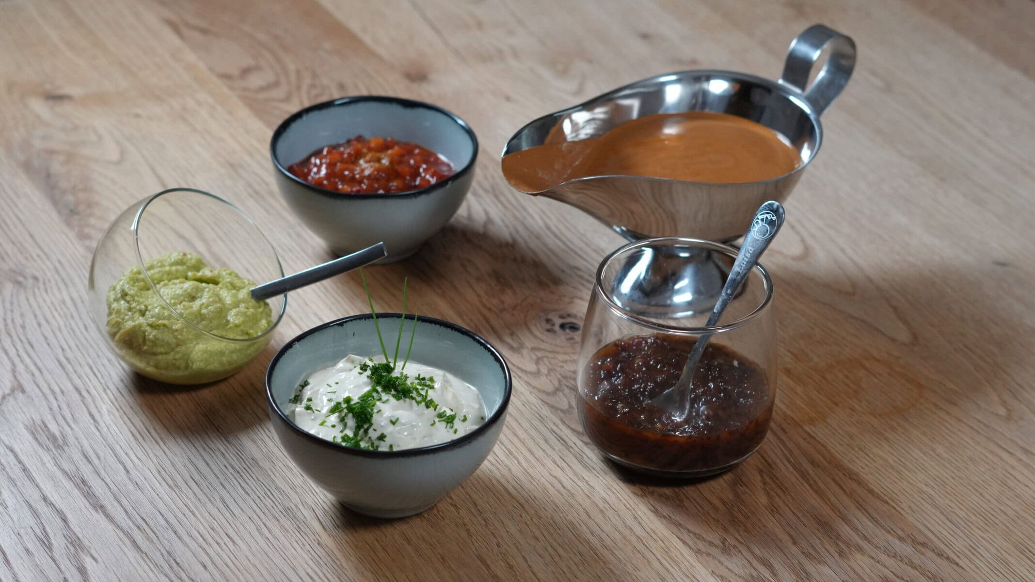 Fünf verschiedene Raclette Soßen und Dips in kleinen Schälchen, serviert mit Brot – Rezept von HausmannKocht.